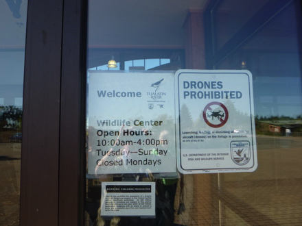Sign at Wildlife Center - Open Hours 10am - 4pm Tuesday - Sunday closed Monday - drones prohibited Sign at Wildlife Center - Open Hours 10am - 4pm Tuesday - Sunday closed Monday - drones prohibited